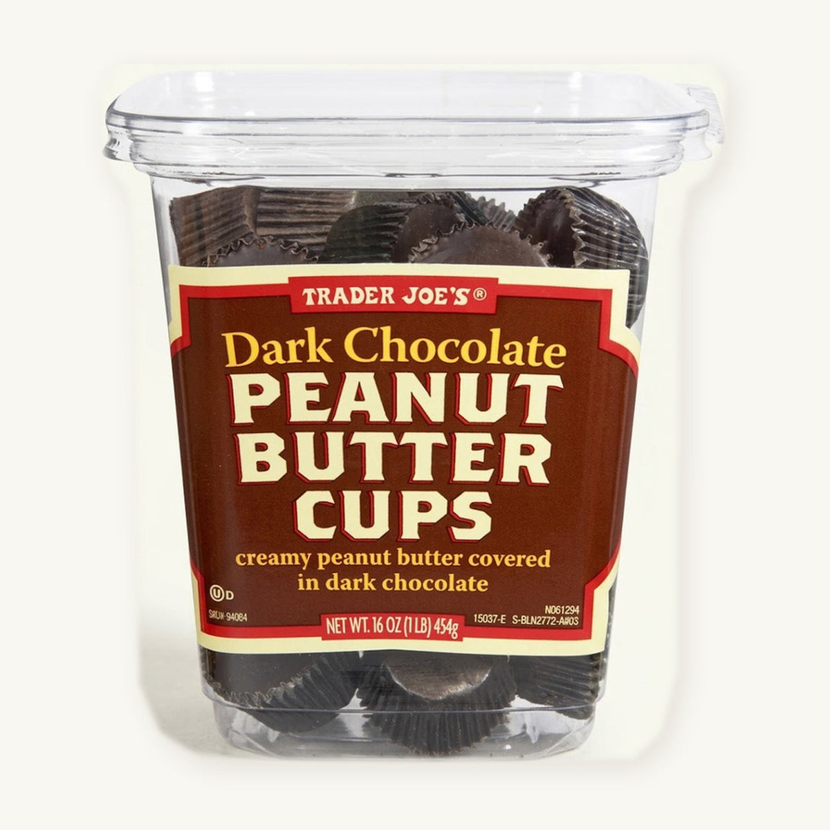 Trader Joe's Dark Chocolate Peanut Butter Cups, 16 oz. Clear tub with a red and black label on a warm ivory background.