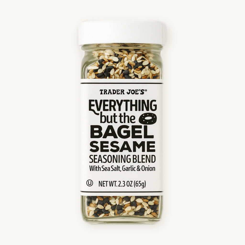 Trader Joe's Everything but the Bagel Sesame Seasoning Blend, 2.3 oz. Clear seasoning bottle with a white label on a warm ivory background.