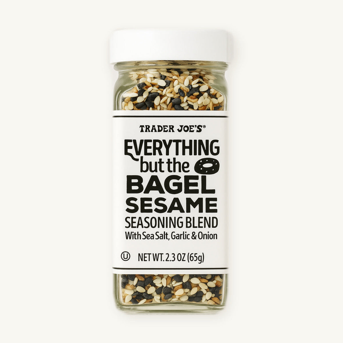 Trader Joe's Everything but the Bagel Sesame Seasoning Blend, 2.3 oz. Clear seasoning bottle with a white label on a warm ivory background.