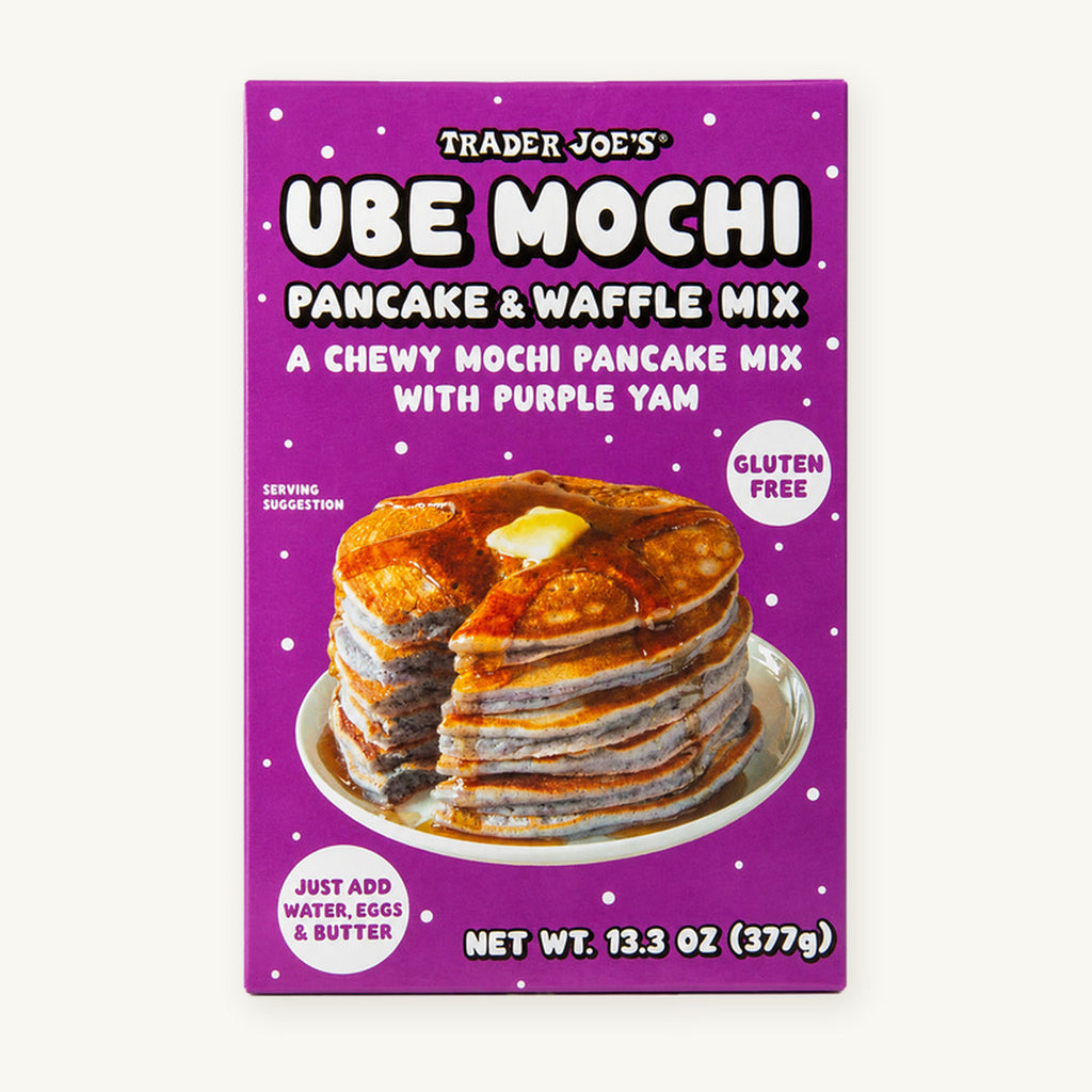Trader Joe's Ube Mochi Pancake & Waffle Mix, 13.3 oz. Purple box showing a stack of pancakes on a warm ivory background.