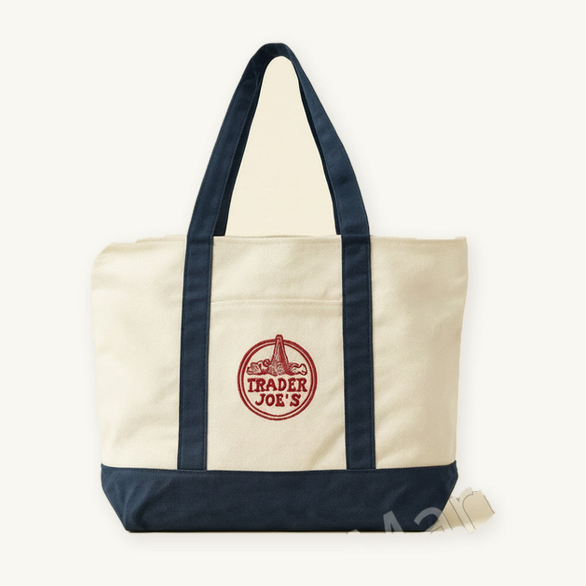 Trader Joe's Large Navy Canvas Bag. Cream canvas tote with navy handles and base on a warm ivory background.