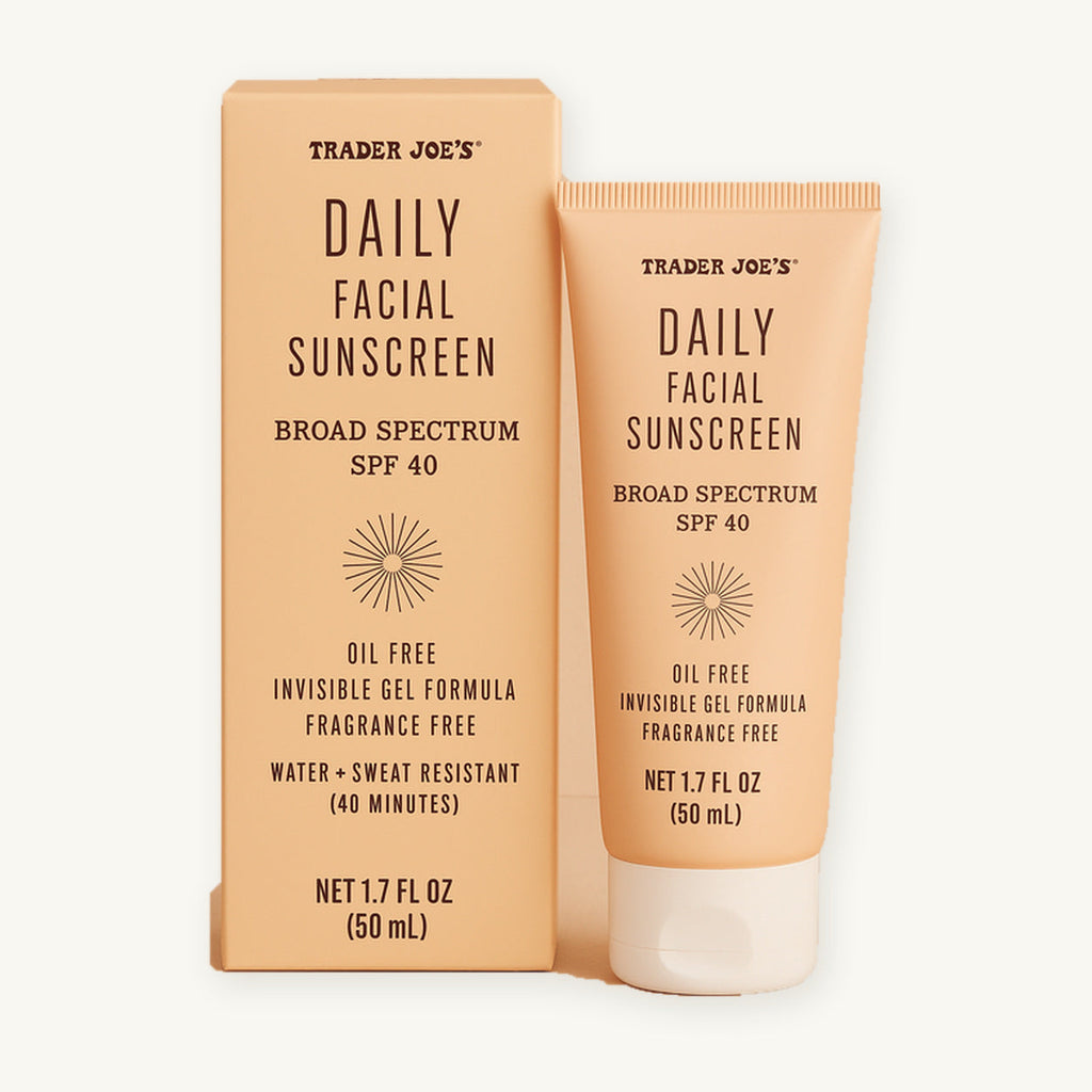 Trader Joe's Daily Facial Sunscreen SPF 40, 1.7 fl oz. Peach-coloured sunscreen tube beside its box on a warm ivory background.