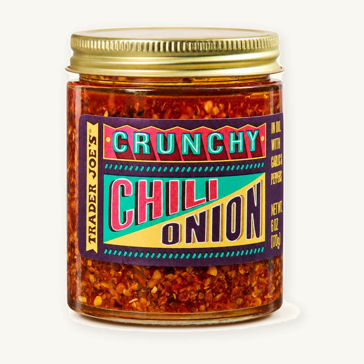Trader Joe's Crunchy Chili Onion, 6 oz. Glass jar with a gold lid and colourful label on a warm ivory background.
