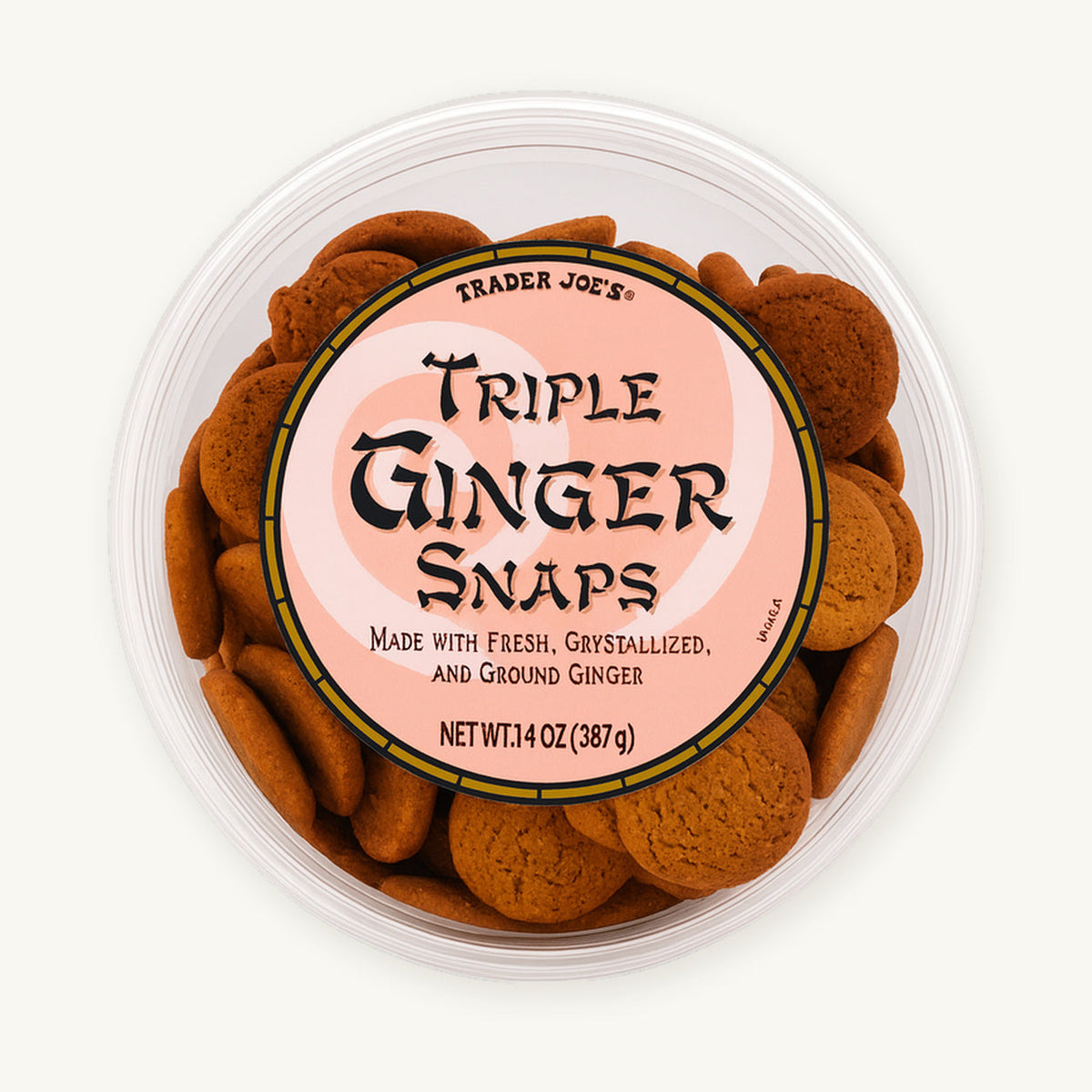 Trader Joe's Triple Ginger Snaps, 14 oz. Round clear tub with a pink label on a warm ivory background.