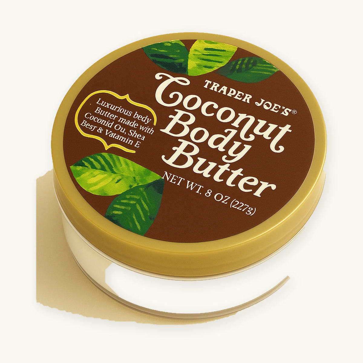 Trader Joe's Coconut Body Butter, 8 oz. Round body butter tub with a gold lid and coconut label on a warm ivory background.