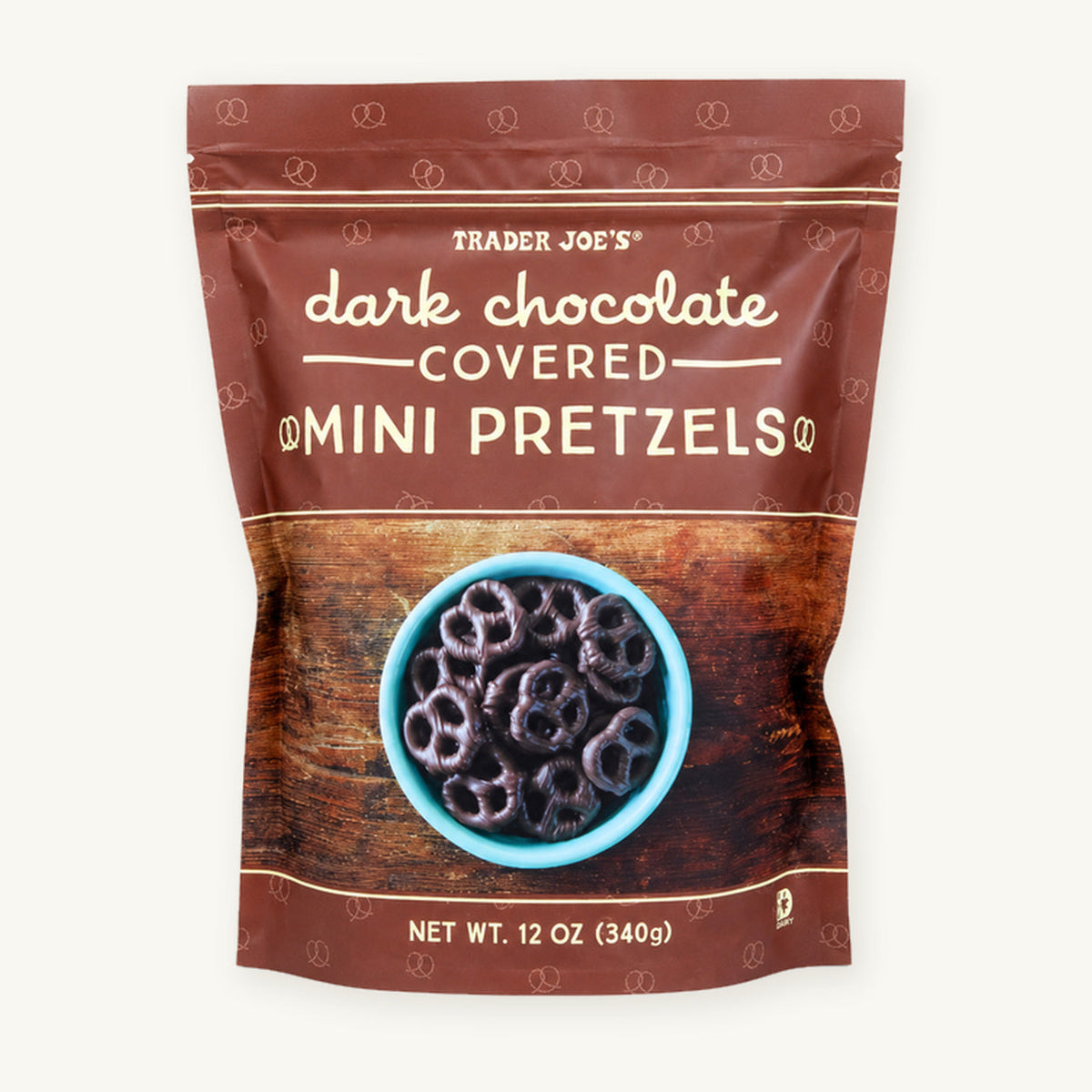 Trader Joe's Dark Chocolate Covered Mini Pretzels, 12 oz. Brown pouch showing chocolate-covered pretzels on a warm ivory background.